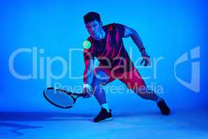 Let the racket do the talking. Blue filtered shot of a tennis player in the studio.