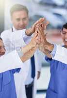 Success is best when achieved as a team. Closeup shot of medical practitioners giving each other a high five.