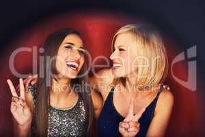 Laughing the night away. Two beautiful young woman enjoying a night out on the town.