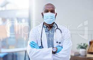 The only thing I want to spread is good medical advice. Shot of a male doctor wearing a surgical mask and gloves.