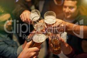 Boys night. High angle shot of guys toasting with beers at a party.