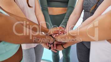 Heres to our self-journeys. Cropped shot of an unrecognisable group of women huddled together with their hands stacked in the middle after yoga.