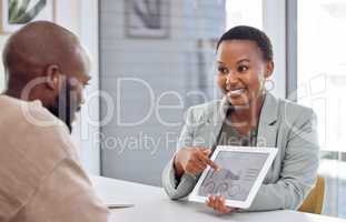 Your idea helped us push our profits. Shot of a businesswoman showing her colleague graphs on a digital tablet.