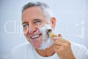 Todays a skincare day. Shot of a mature man applying shaving cream to his face in a bathroom at home.