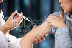Itll only hurt for a few seconds. Shot of a woman receiving an injection at a Covid-19 vaccination centre.
