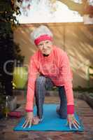 Ready to lunge. Shot of a senior woman exercising at home.