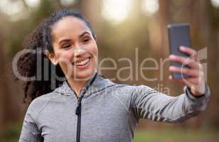 Like and subscribe if you want more fitness tips. Shot of a fit young woman taking a selfie while out for a run.