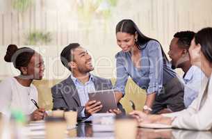 Explore business ideas freely. Shot of a group of coworkers using a digital tablet during a business meeting.