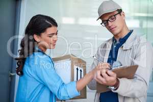 Thank you for such a swift service. Shot of a young woman signing for a delivery from the courier.