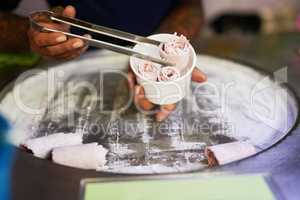 Expertly prepared just for you. Shot of an unidentifiable food vendor preparing a sweet treat at a market stall.