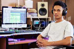 Beats by me. Cropped portrait of a handsome young male music producer working in his home office.