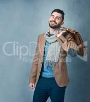 Style doesnt compete because its unique. Studio shot of a stylishly dressed young man posing against a grey background.