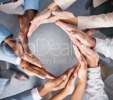 Solidarity makes the world go round. Shot of a group of businesspeople joining hands in solidarity.