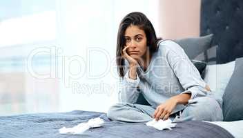 Nothing challenges your patience like a pandemic. Shot of a young woman recovering from an illness in bed at home.