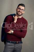 Hes dressed to really impress. Studio portrait of a handsome young man posing against a grey background.