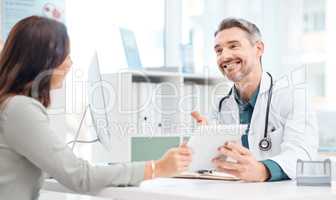 Medication isnt always necessary, but belief in recovery always is. Shot of a mature doctor using a digital tablet during a consultation with a patient in a medical office.