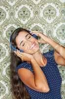 Unwinding this weekend. Shot of an attractive young woman listening to music.