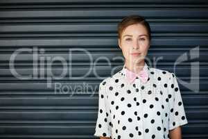 Bold enough to be myself. Portrait of a trendy young woman standing against a corrugated background.