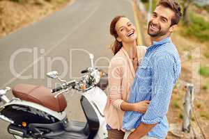 Were having so much fun out on the road. Shot of an adventurous couple out for a ride on a motorbike.