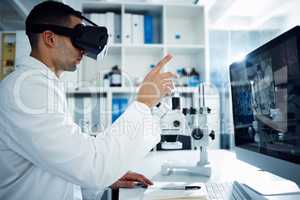 The future is reserved for the progressive. Shot of a scientist using a virtual reality headset while conducting research in a laboratory.