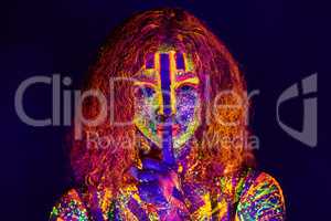 Beauty in neon. Cropped portrait of a young woman posing with neon paint on her face.