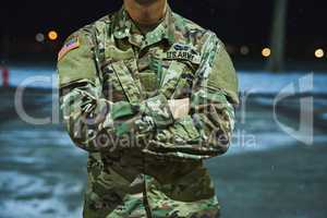 True soldiers stand their ground. Cropped shot of a soldier standing outside on a cold night at a military academy.