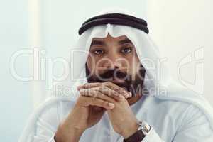 At my best when Im in my office. Cropped portrait of a young businessman dressed in Islamic traditional clothing working in his office.