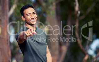 Hey you Get off the couch and come run with me. Portrait of a sporty young man pointing outdoors.