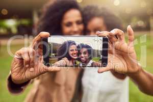 The ultimate selfie queens. Cropped shot of two female best friends taking a picture in a public park.