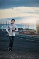 Fitness should be a lifetime commitment. Shot of a sporty young man out for a run.