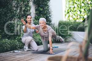 Fear of the future only ruins the present. Shot of an older woman doing light floor exercises during a session with a physiotherapist outside.