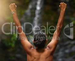 Jungles are the best. Rearview shot of an unidentifiable person celebrating a victory in the jungle.