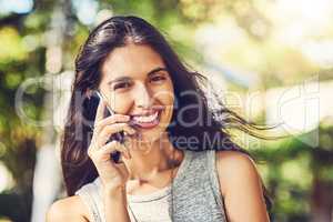 I cant survive without my connections. Portrait of an attractive young woman talking on a cellphone outdoors.