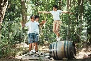 If your childhood looked like this, you had an awesome one. Shot of a group of teenagers having fun with a barrel in nature at summer camp.