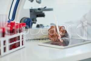 Making advances in the health sciences. Closeup shot of a female scientist recording her findings on a digital tablet.