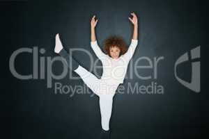 When words fail, dance triumphs. Studio shot of an attractive young woman dancing against a gray background.