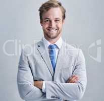I know the secret to success. Studio shot of a businessman in a grey suit posing against a grey background.