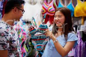 Do you think itll suit me. Shot of a young woman asking her boyfriends opinion on a bathing suit.