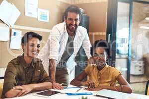 Were here to set new heights. Portrait of a diverse group of businesspeople working together in an office.