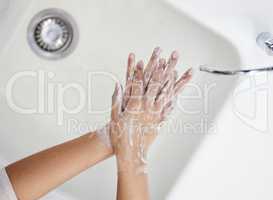 Wash your hands thoroughly. Shot of an unrecognizable person washing their hands at home.