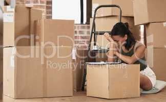 To some moving house is just another habit. Shot of a young woman having a stressful day during packing at home.