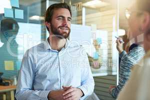 Id be interested to hear your ideas in depth. Shot of businesspeople brainstorming in an office.