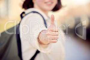 Do good and youll attract good. Cropped shot of a woman showing thumbs up while standing outside.