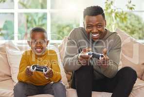 Im going to kick your butt. Shot of a father and son gaming together.