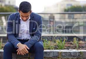 Life can make any man weary. Shot of a young businessman looking upset.