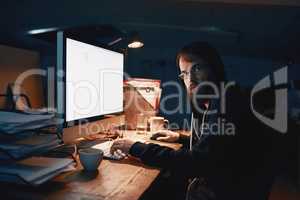 Late nights are normal for a programmer. Cropped portrait of a young computer programmer working late in the office.