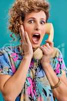 What Thats terrible news. Studio shot of a young woman holding a telephone while wearing 80s clothing.