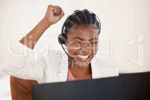 Ill earn extra commission on this one. Shot of a young call centre agent cheering while working on a computer in an office.