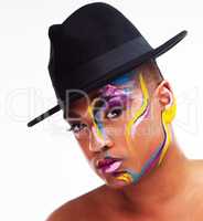Be unapologetically you. Portrait of a gender fluid young man wearing face paint and a hat posing against a white background.