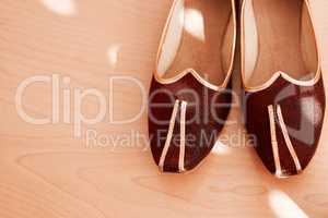 Style paired perfectly with culture. Shot of two formal mens shoes on the floor of a bedroom.